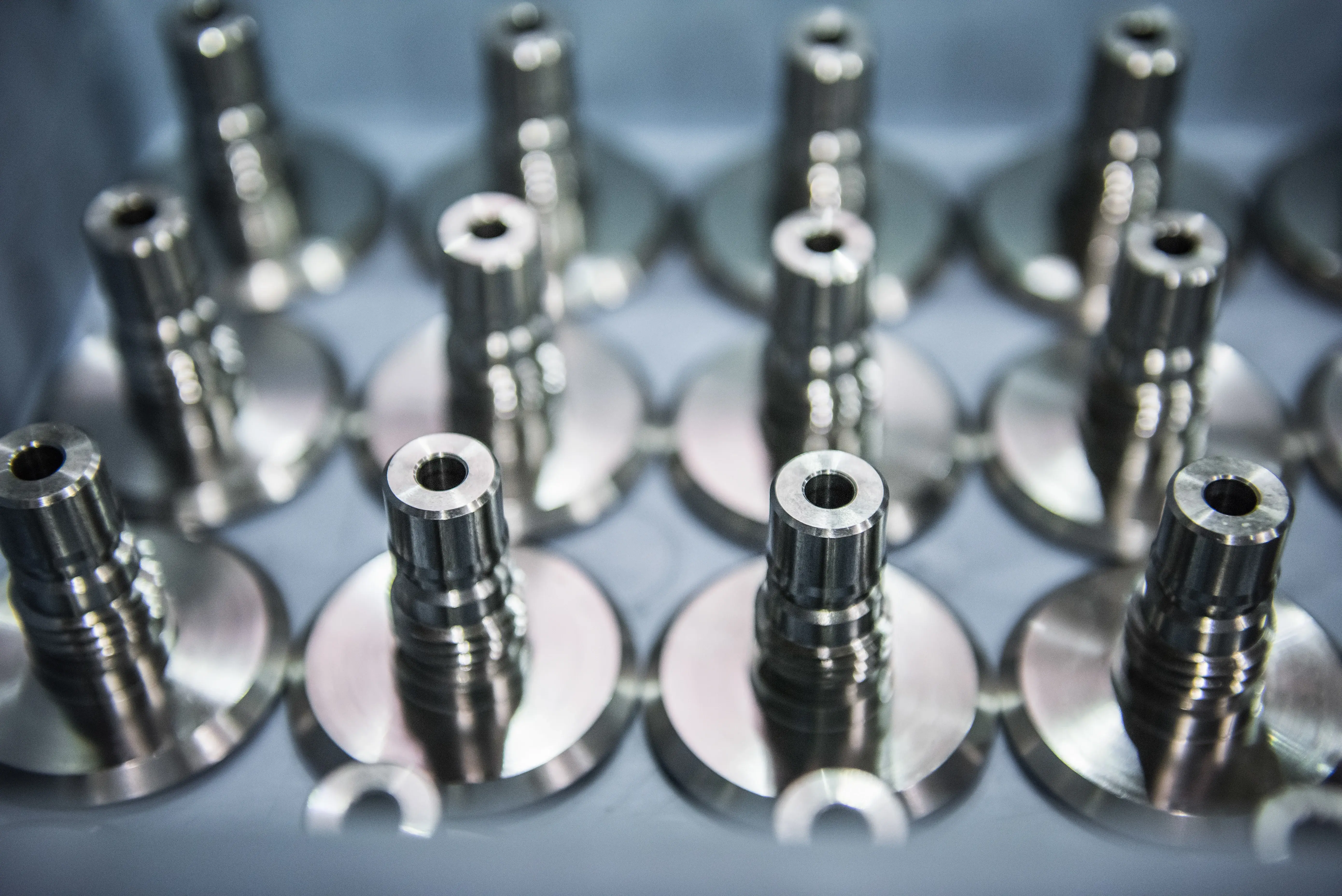 Precision CNC turned metal components arranged in a production tray, showcasing high-accuracy machined parts ready for assembly.