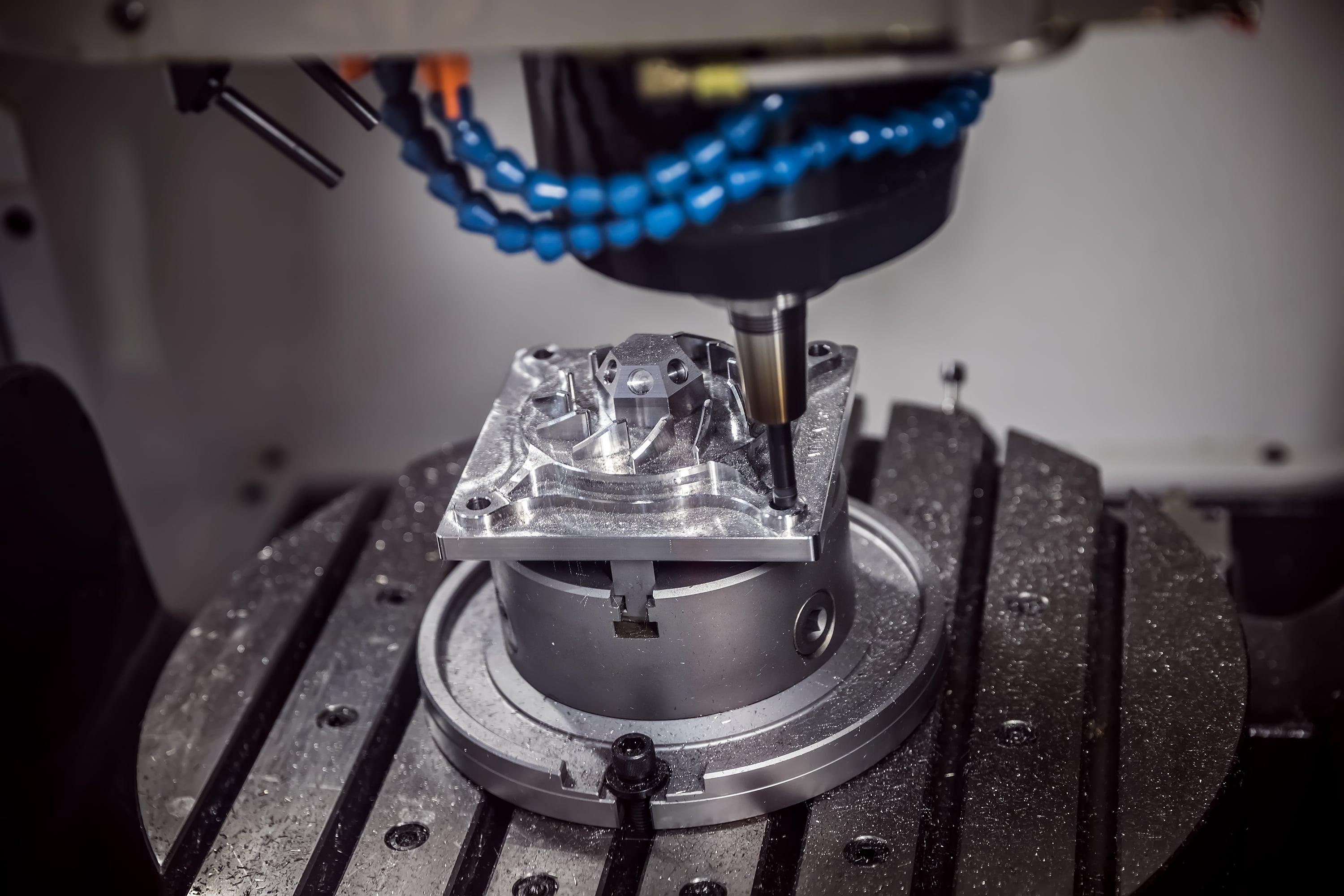 CNC milling machine producing a precision metal part during machining.